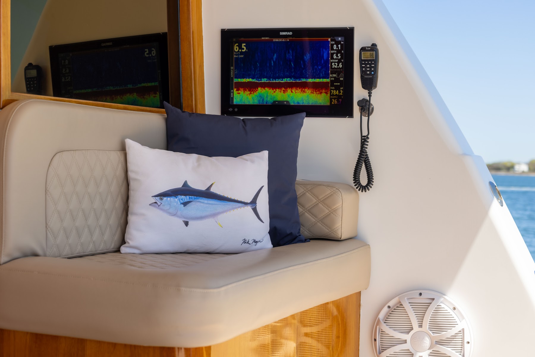 Detail photography of diamond-stitched upholstery and marine electronics